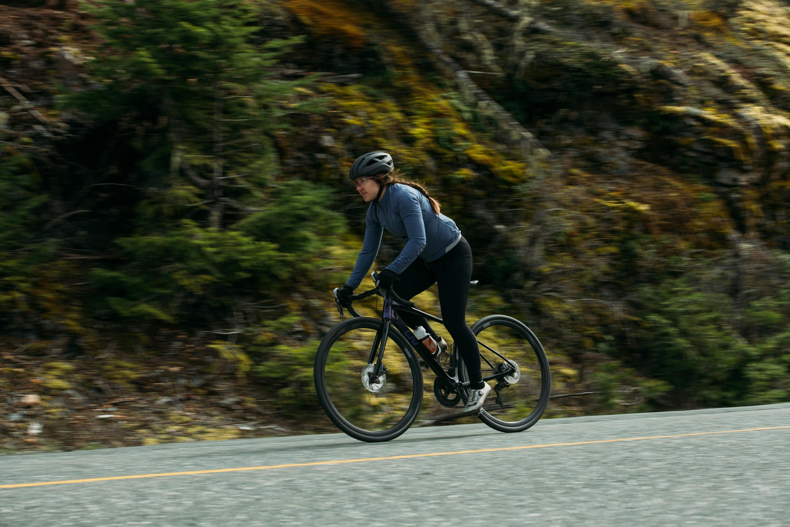 Woman riding a bike on the road.