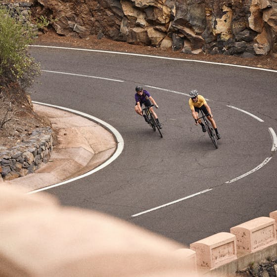 Man and woman riding a bike on road