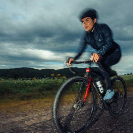 Woman riding a bike on gravel