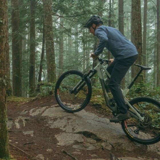 Man on a bike wearing blue jacket