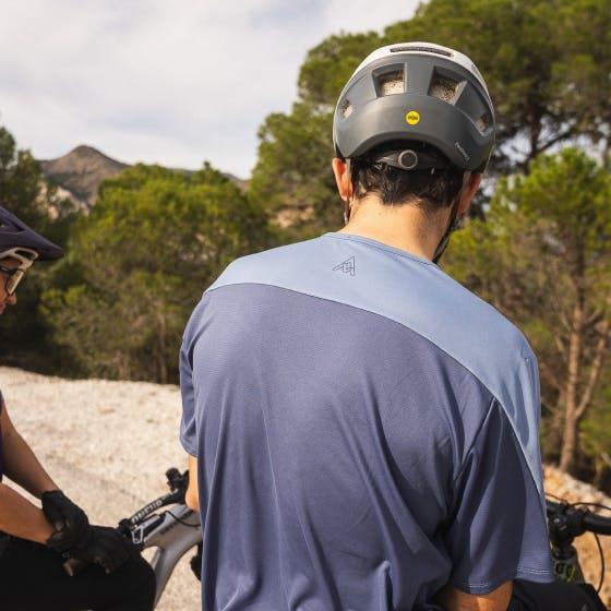 Man wearing a blue shirt sitting on a bike