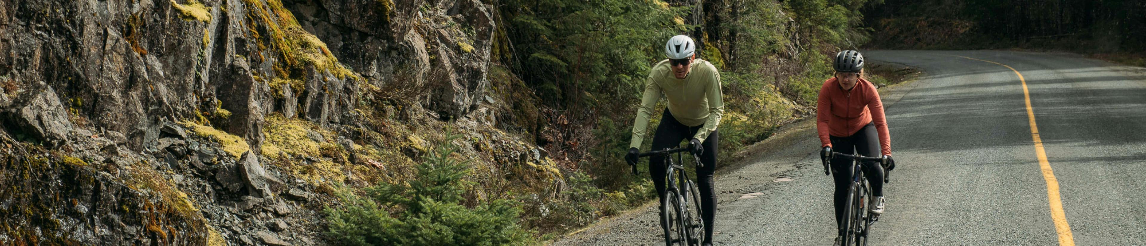 Two people out for a road bike ride coming towards the camera with speed