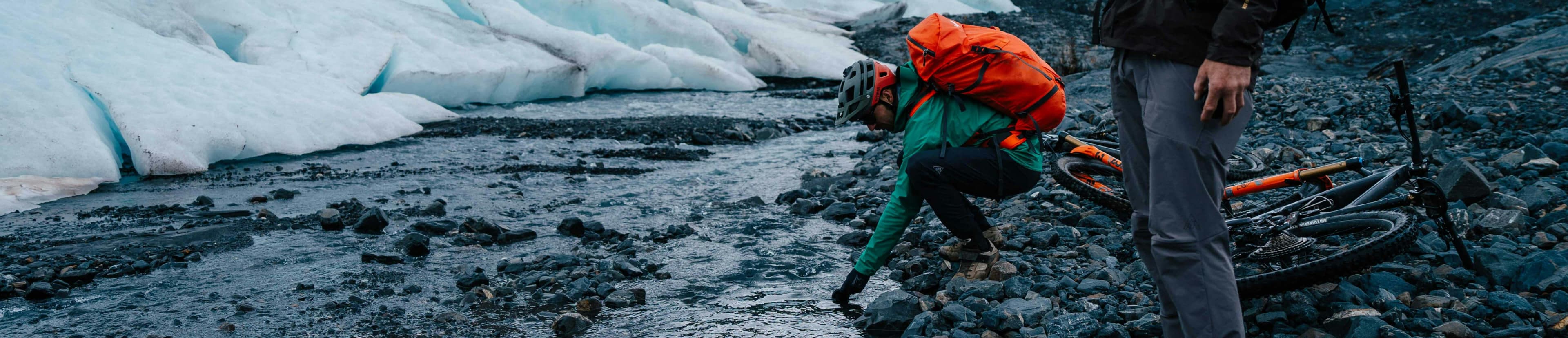 Two men wearing winter jackets beside the glaciar