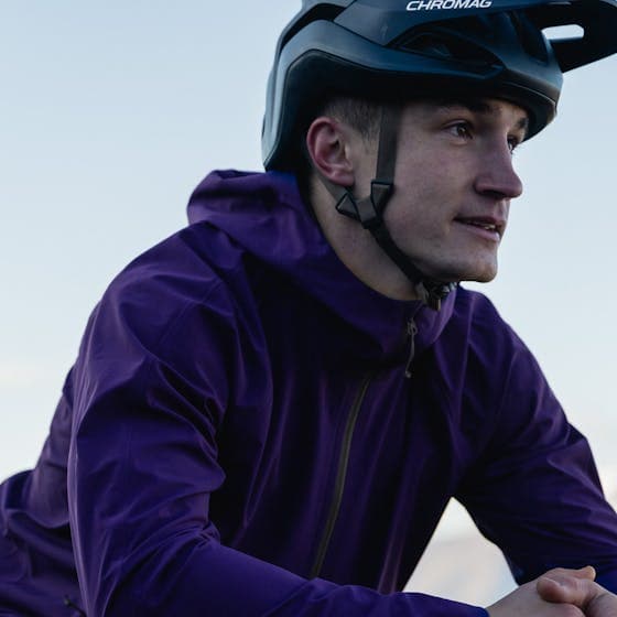 Man wearing a helmet and a purple jacket