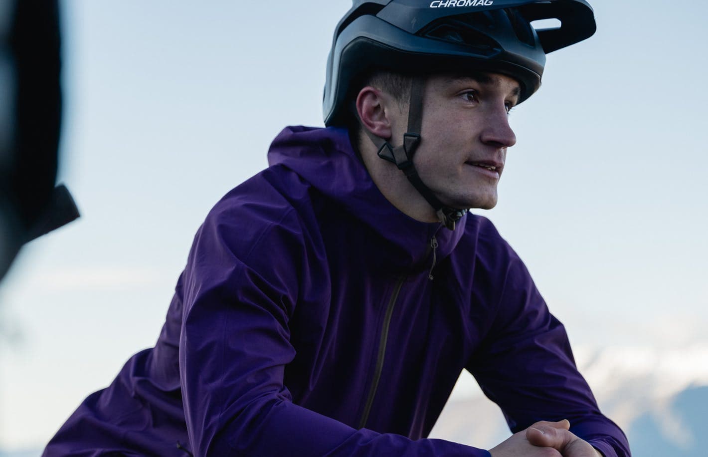 Man wearing a helmet and a purple jacket