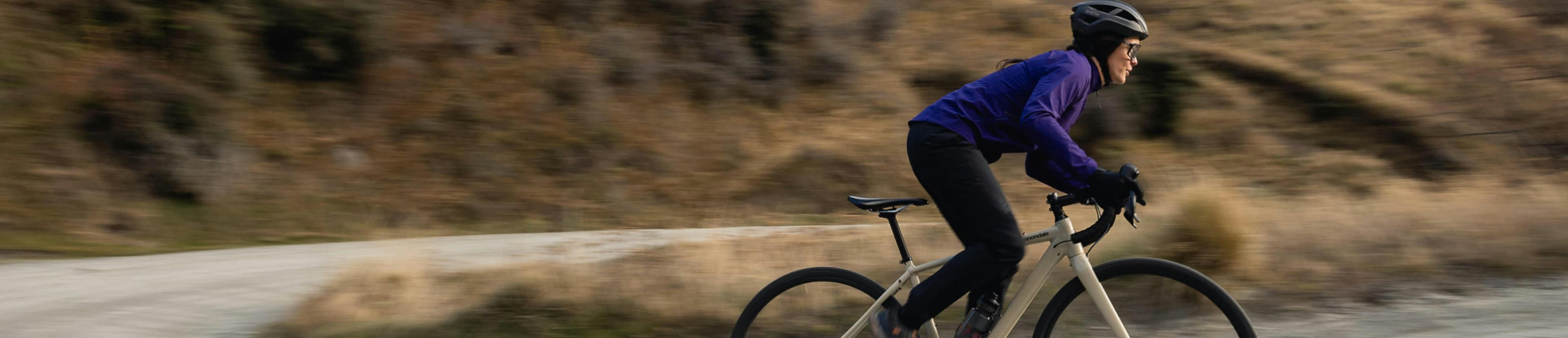 Womam riding a bike on a purple jacket