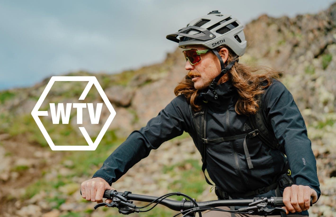 WTV logo and a man wearing a helmet and riding a bike