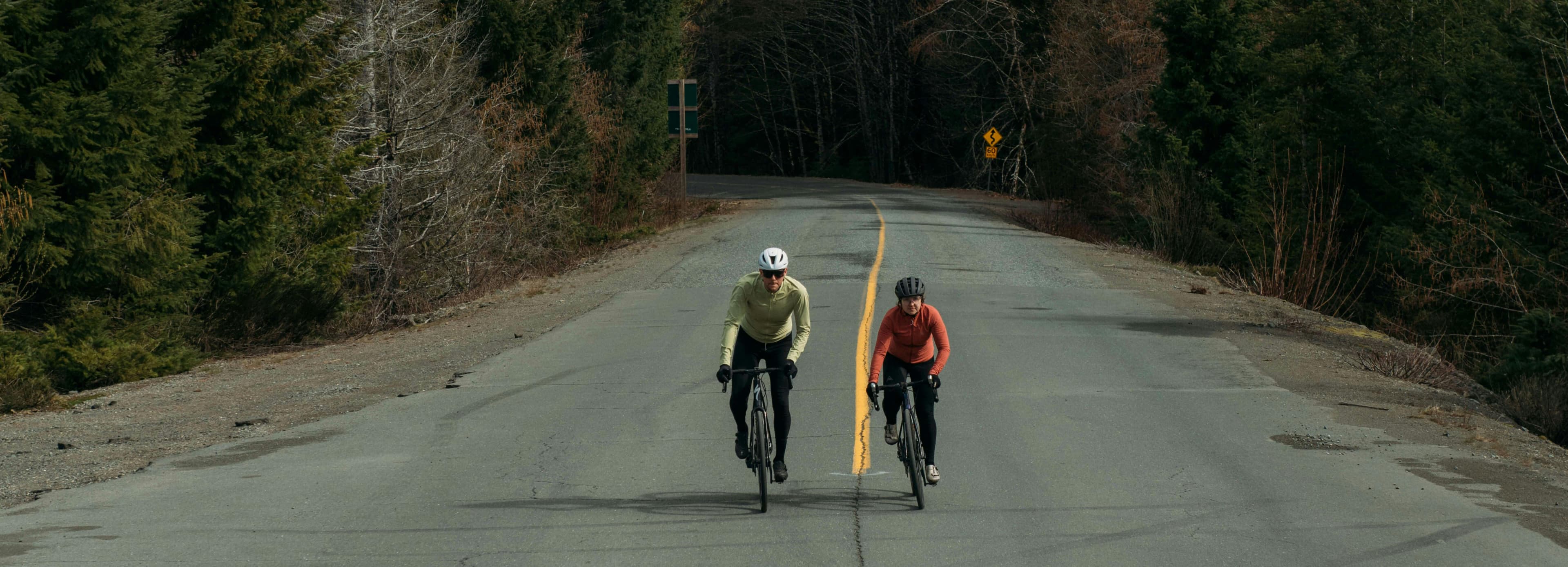 Man and woman riding their bikes on the road